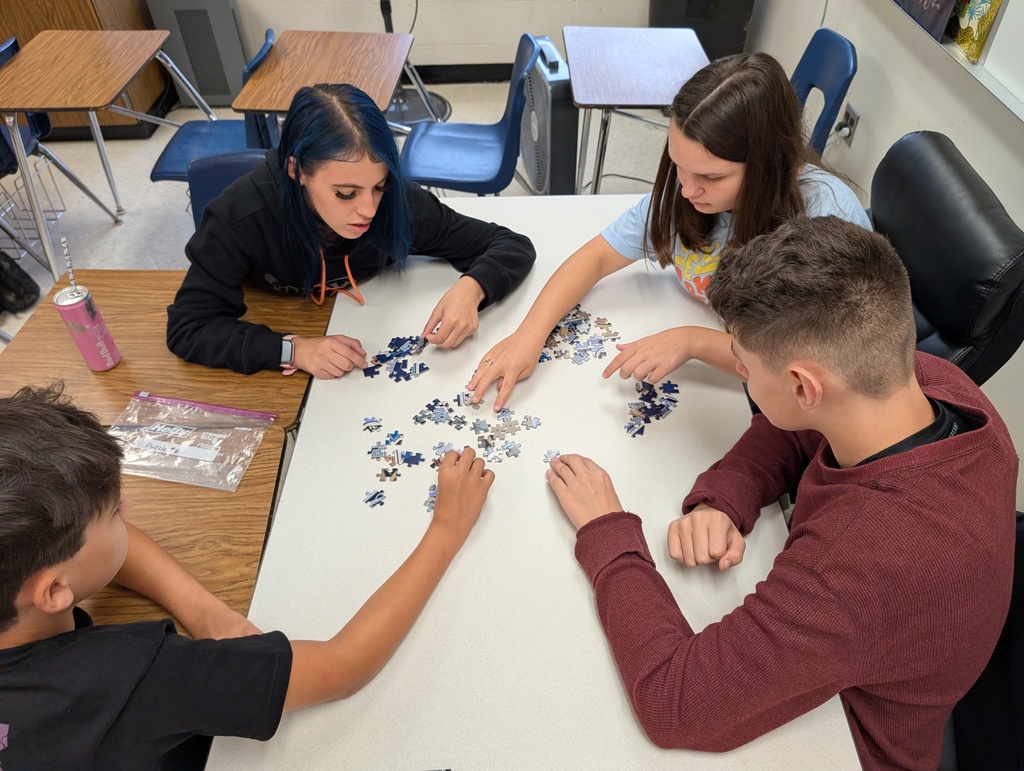 small group of students working on a jigsaw puzzle