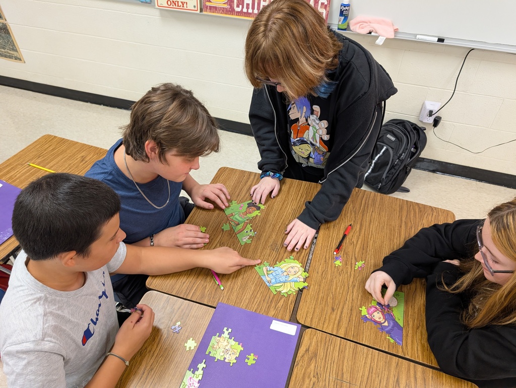 small group of students working on a jigsaw puzzle