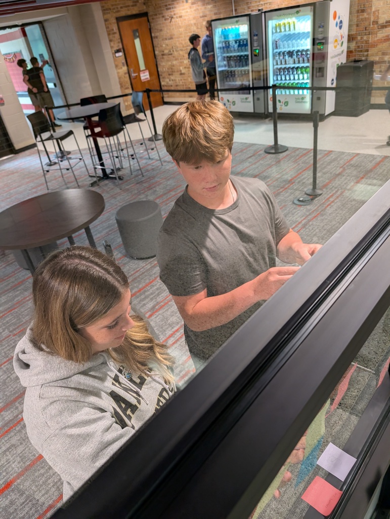 two students working together on a school assignment