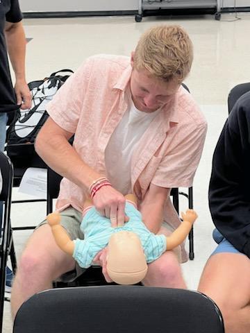 student practicing CPR for training