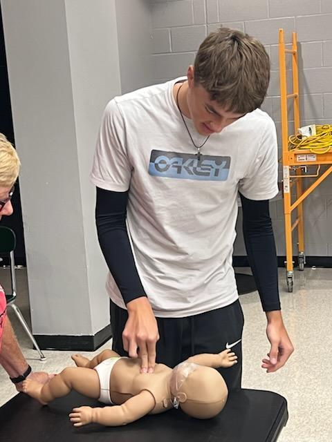 student practicing CPR for training