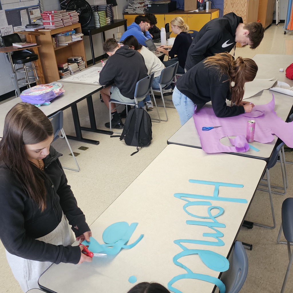 student council students working on paper crafts and signs