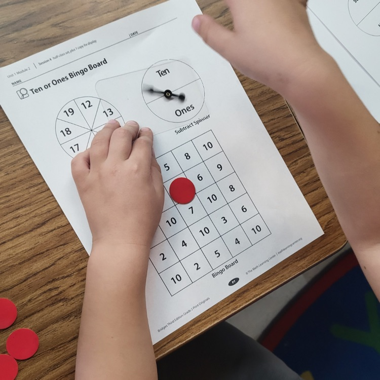 Having fun and learning with Tens or Ones Bingo in Mrs. Raymer's class.