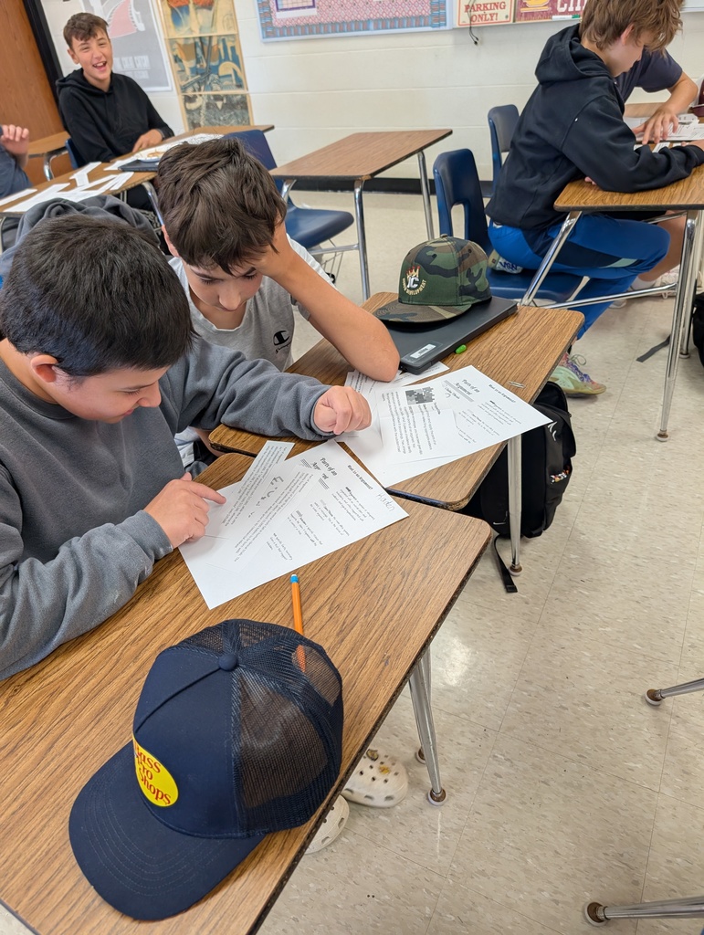 two 8th grade students working together on an assignment