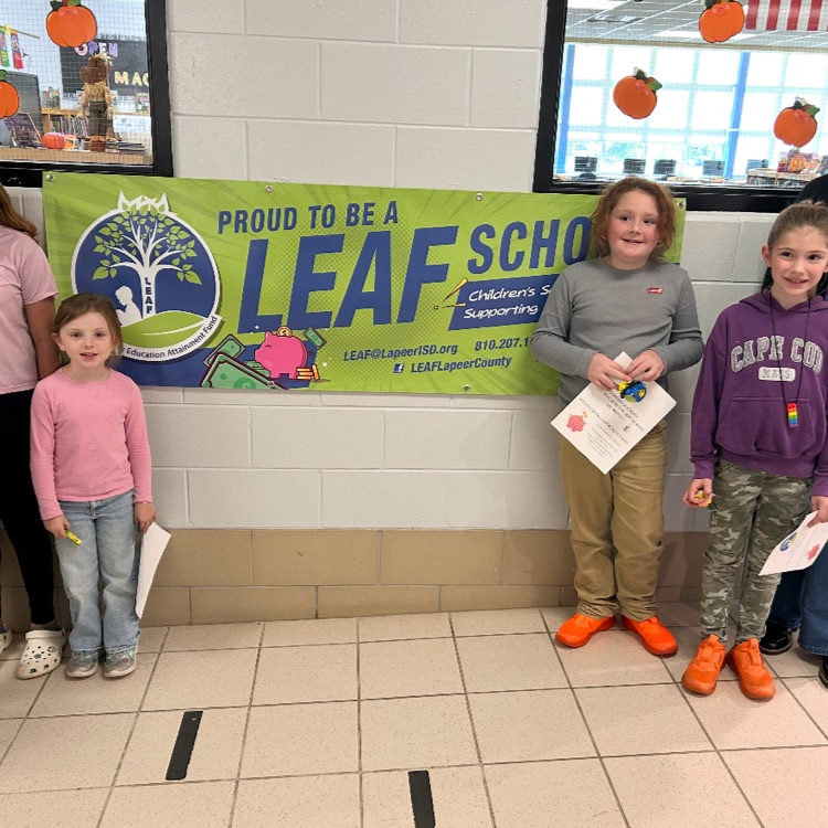 students in front of a LEAF banner