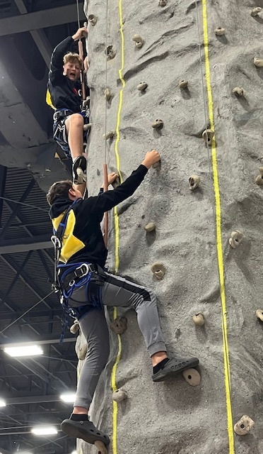 two students on climbing wall