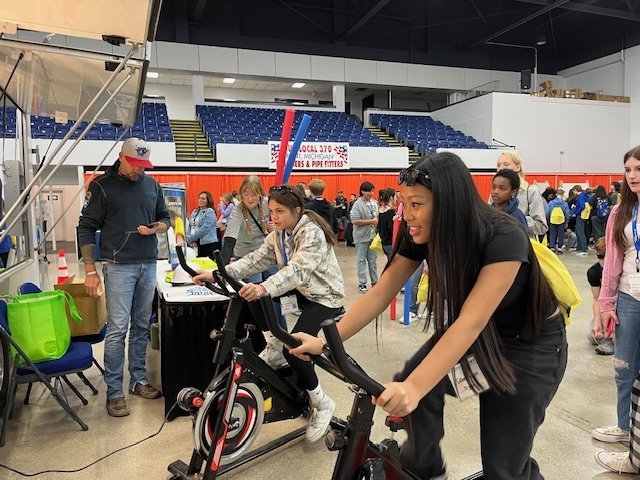 two students on stationary bikes