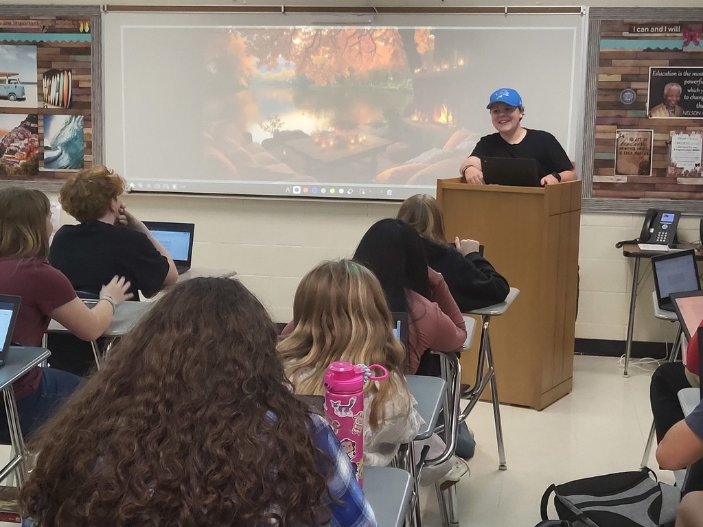 student at a podium telling a story to classmates