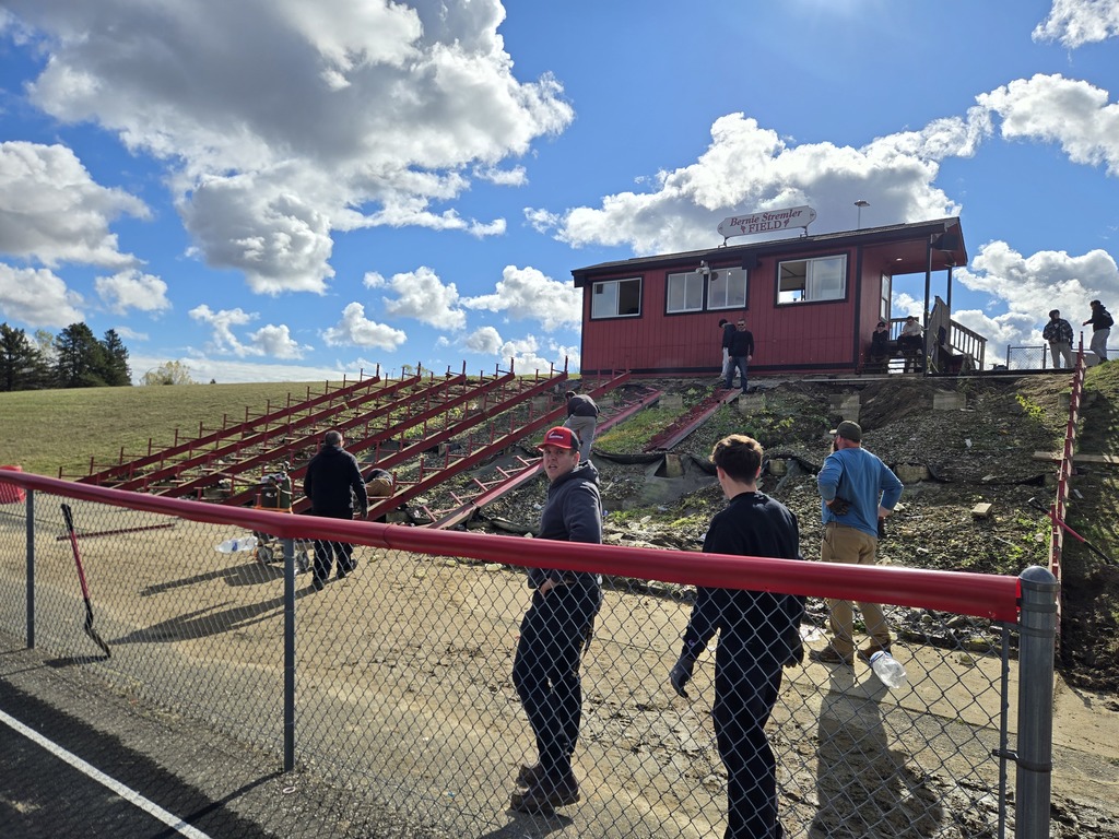 photo of a group of volunteers removing outdoor bleachers