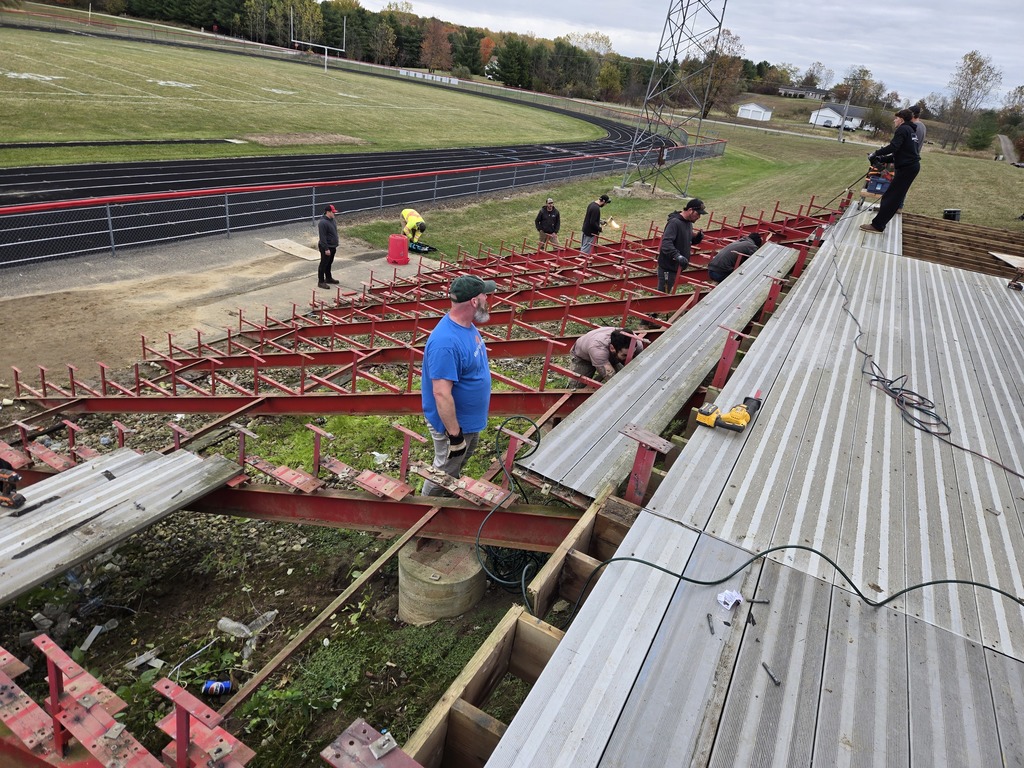 photo of a group of volunteers removing outdoor bleachers