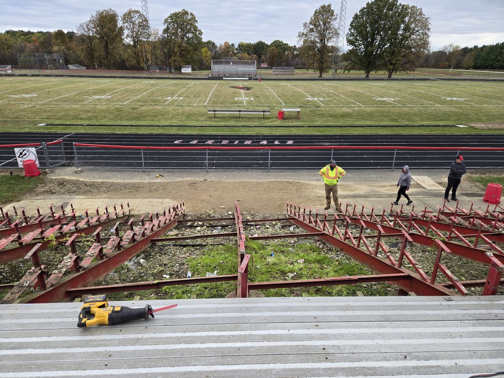 photo of a group of volunteers removing outdoor bleachers