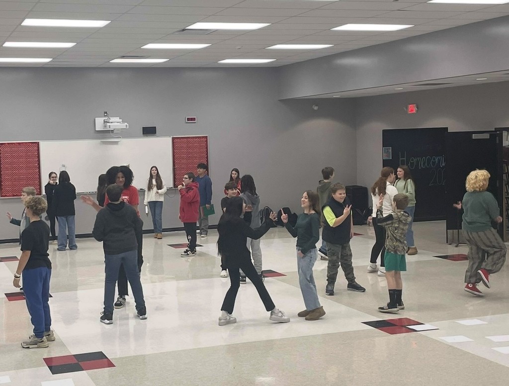 middle school students completing an activity about achieving excellence