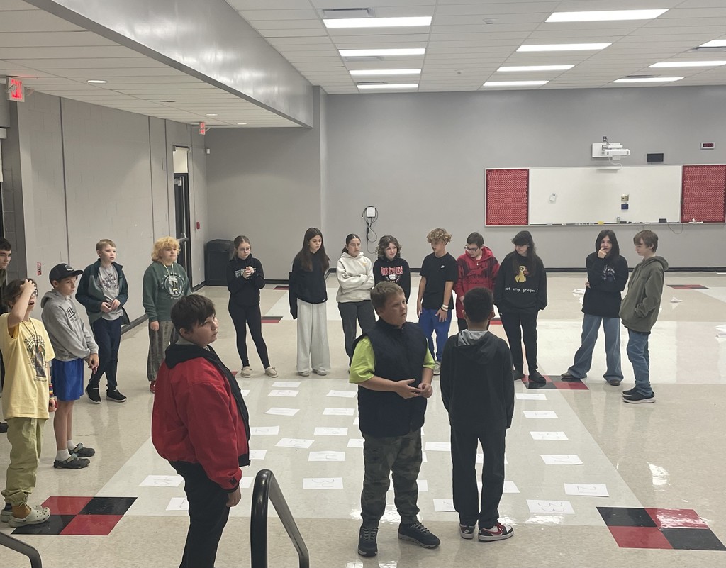 middle school students completing an activity about achieving excellence