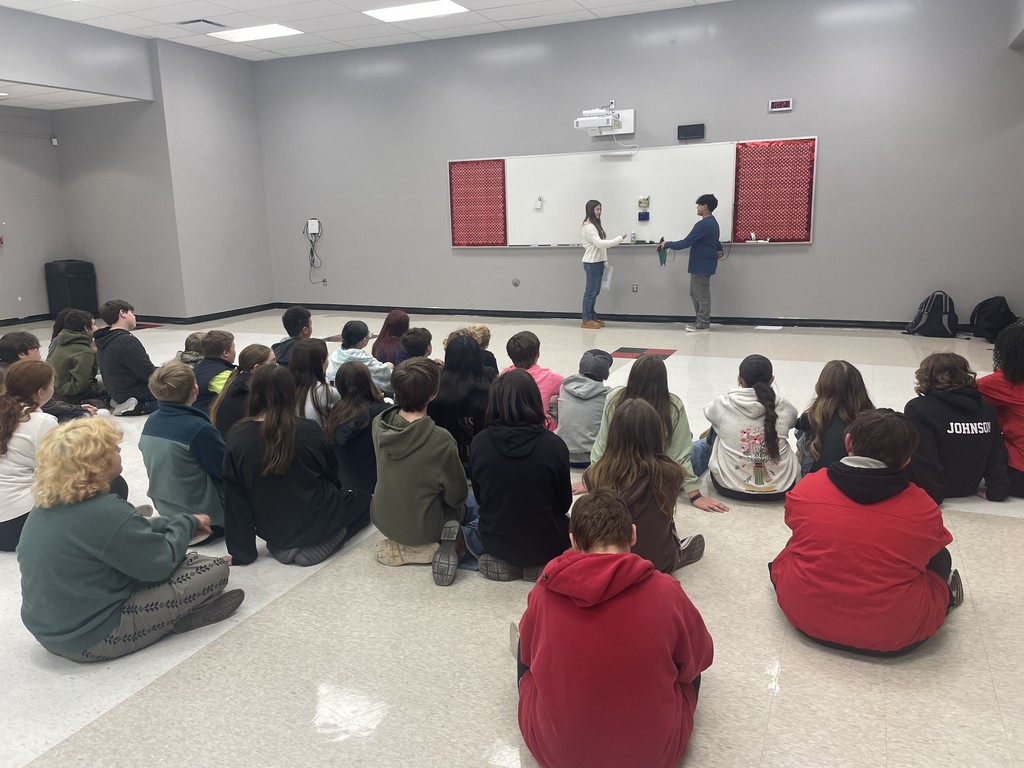 middle school students completing an activity about achieving excellence