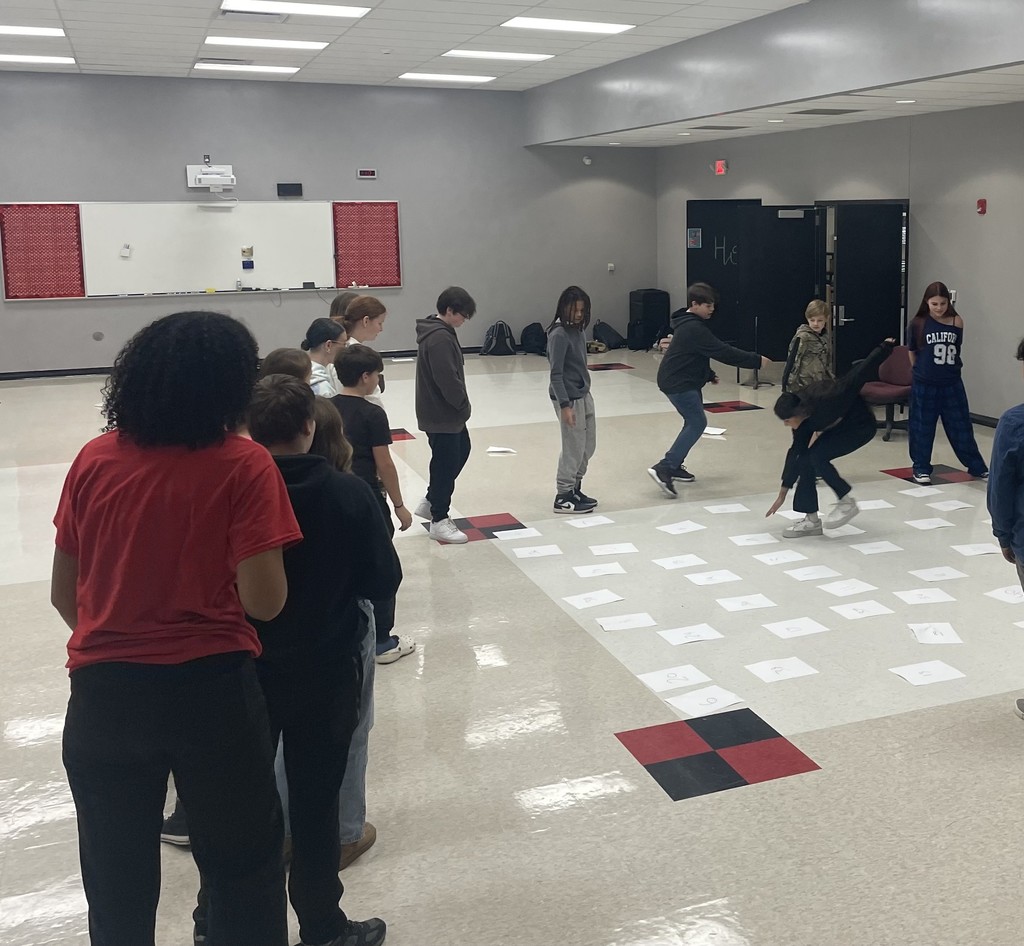 middle school students completing an activity about achieving excellence