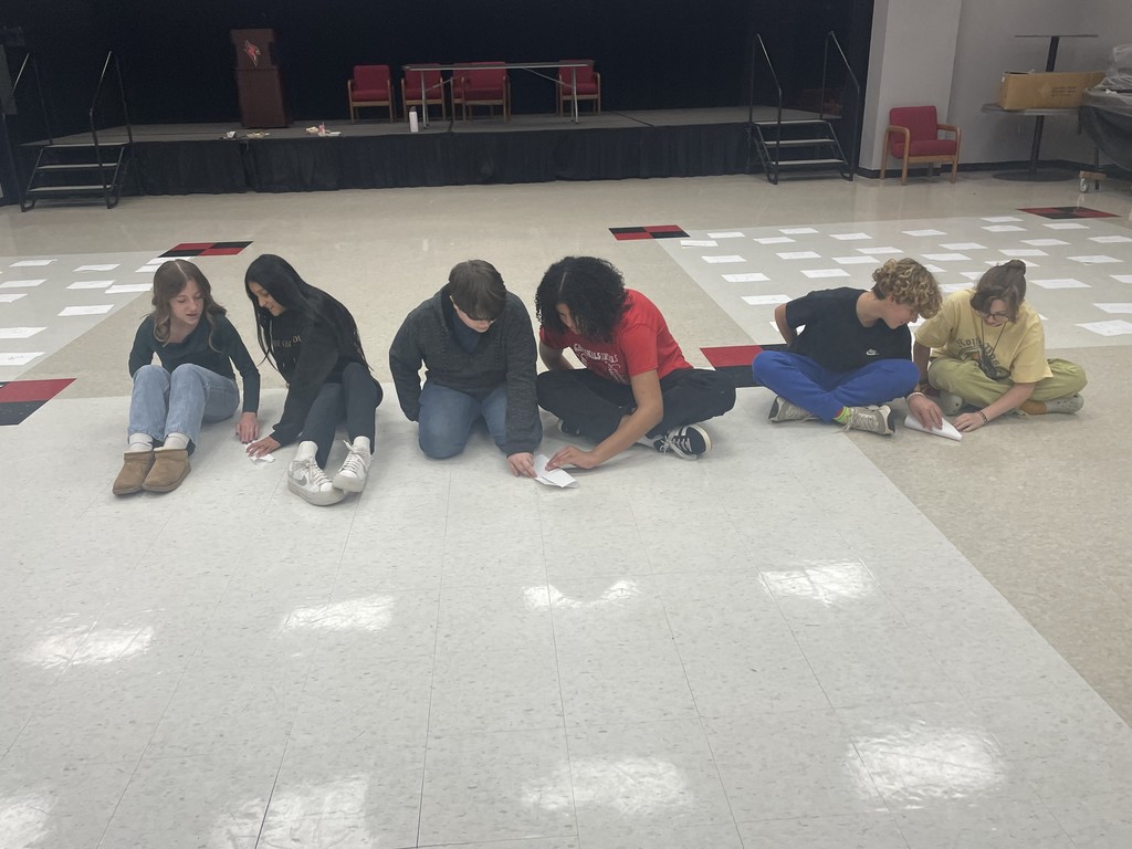 middle school students completing an activity about achieving excellence