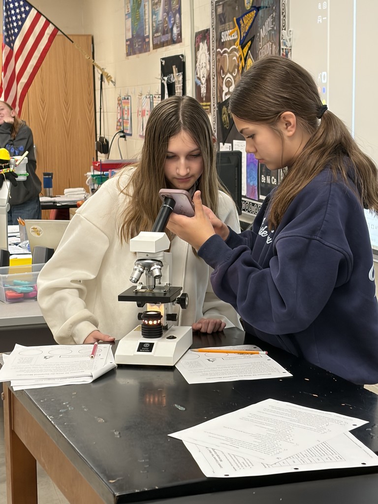 eighth grade students completing a science lab on microscopes