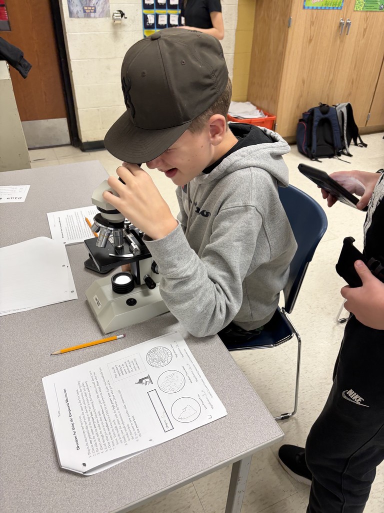eighth grade students completing a science lab on microscopes