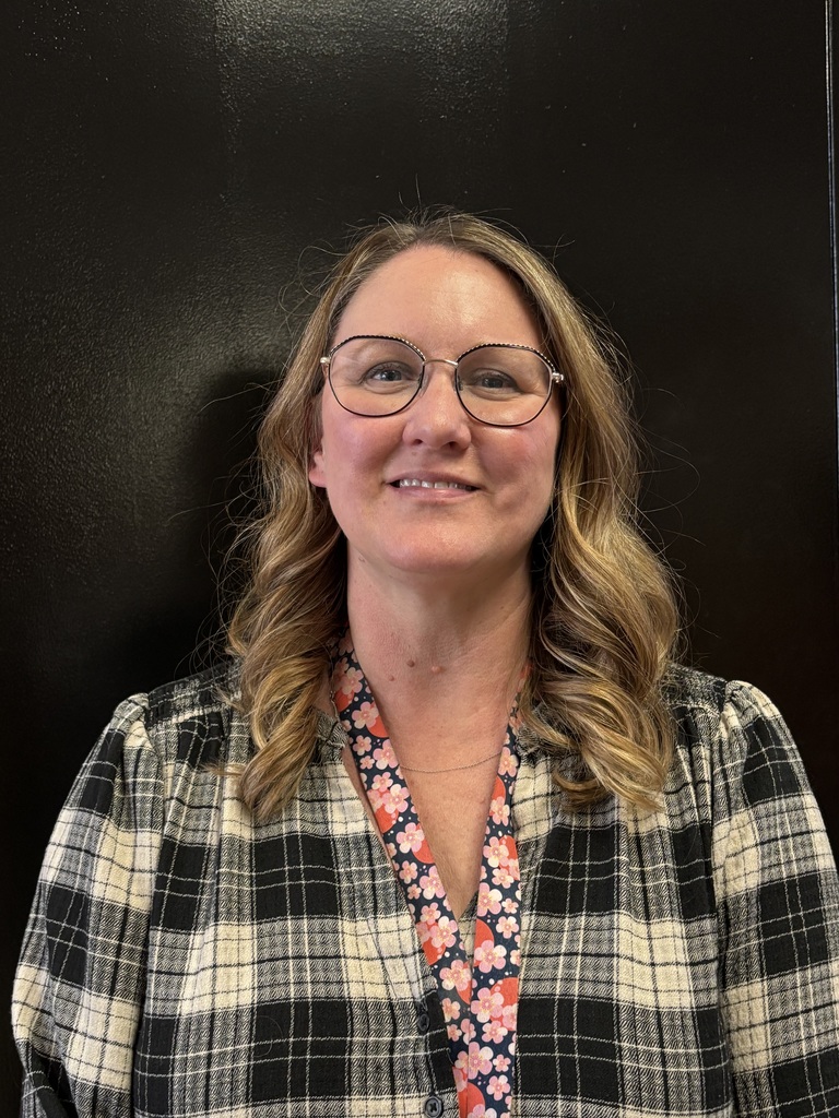 a teacher smiling because she did a good job!