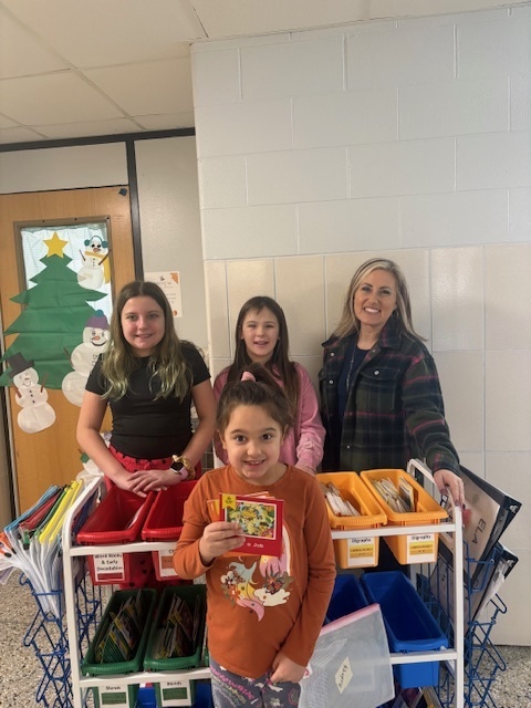 5th grade Student Library Board members helped Mrs. White with the distribution of Friday take-home books for Kdg and 2nd grade. They like to call themselves “book fairies”!