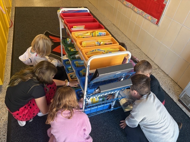 5th grade Student Library Board members helped Mrs. White with the distribution of Friday take-home books for Kdg and 2nd grade. They like to call themselves “book fairies”!