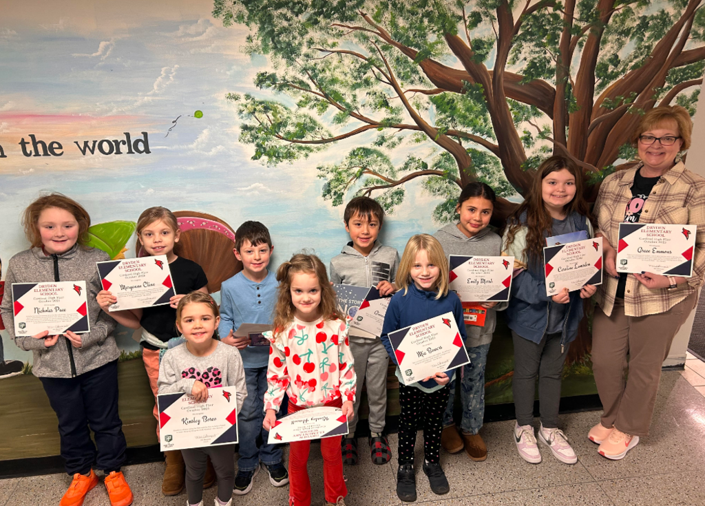 students with a principal holding up certificates