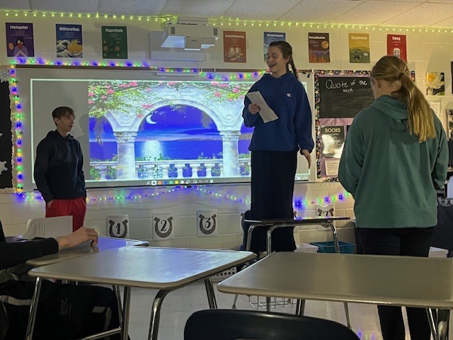 ninth grade students performing the Romeo and Juliet balcony scene in a classroom