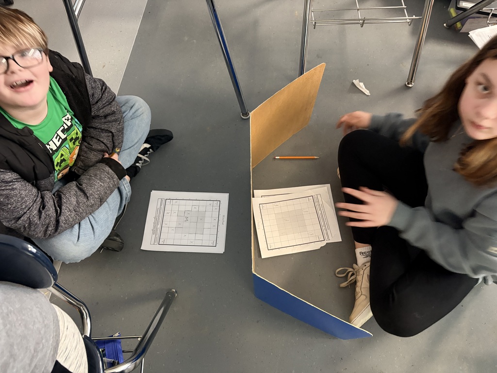 Mrs. Howell’s 6th graders are preparing to read the 4th book in the Percy Jackson Series, which is called The Battle of the Labyrinth. They spent the day battling it out Battleship style with a game where one student plays the Minotaur who has placed walls and traps for the other person to avoid as Theseus, who is trying to get to the potions and sword that were stashed around the Labyrinth. Students are using skill and strategy as they venture deep into the unknown!