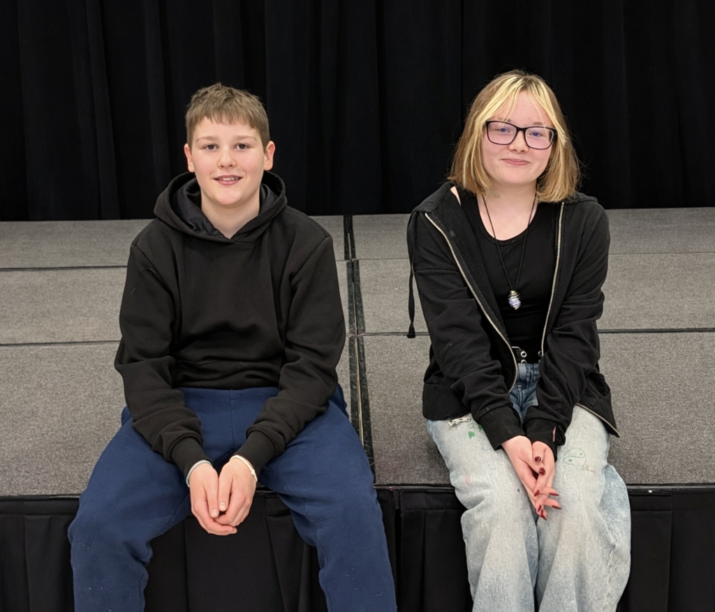 two junior high students sitting