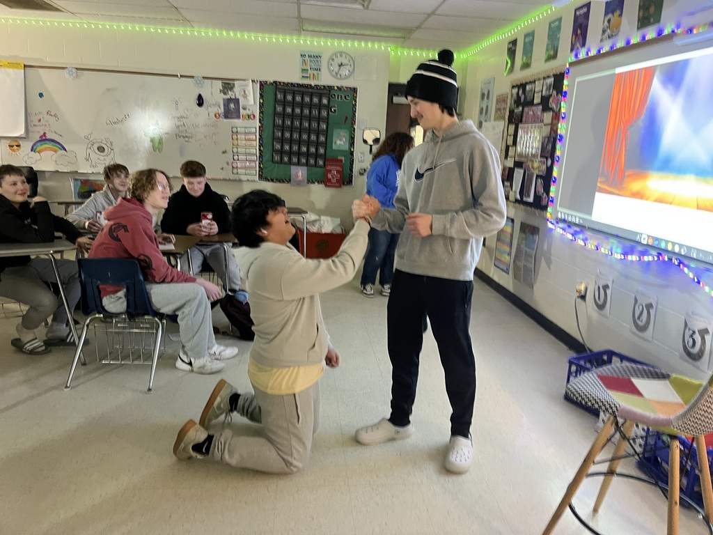 high school students creating a freeze frame of Romeo and Juliet