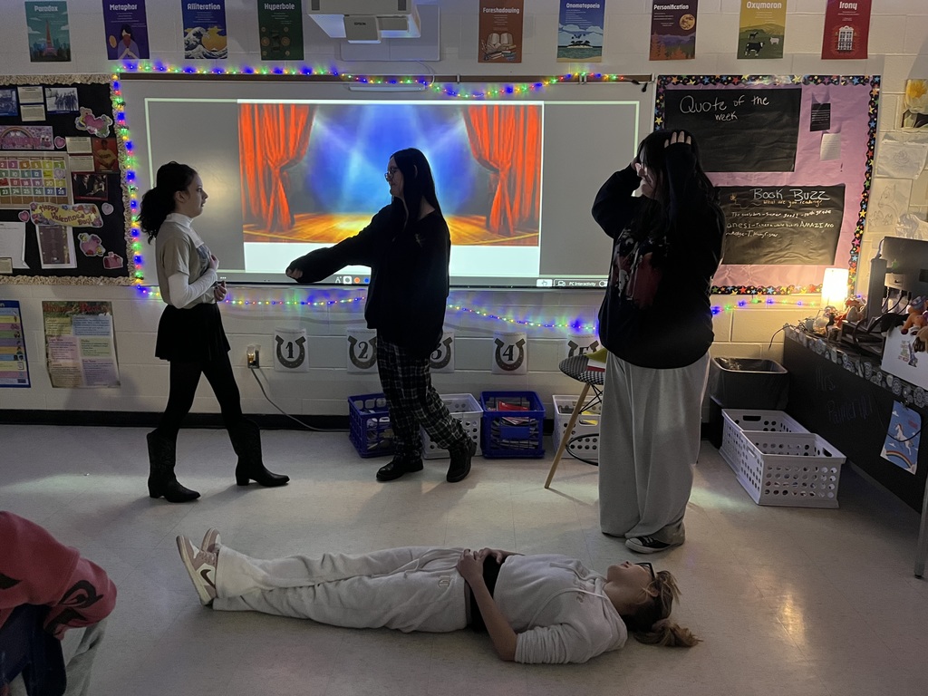 high school students creating a freeze frame of Romeo and Juliet