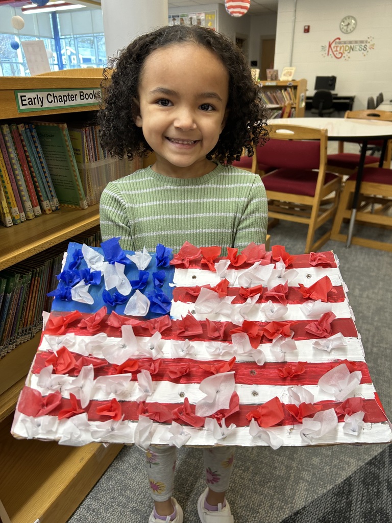 student holding a flag she made