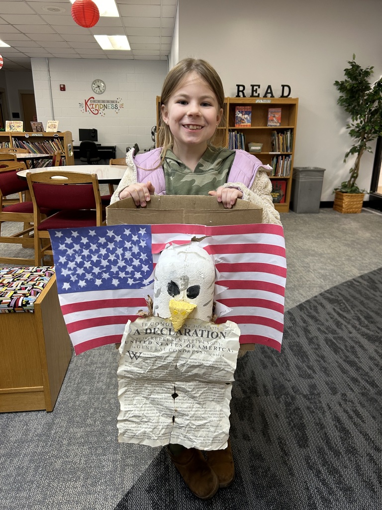 student holding a flag and declaration of independence she made