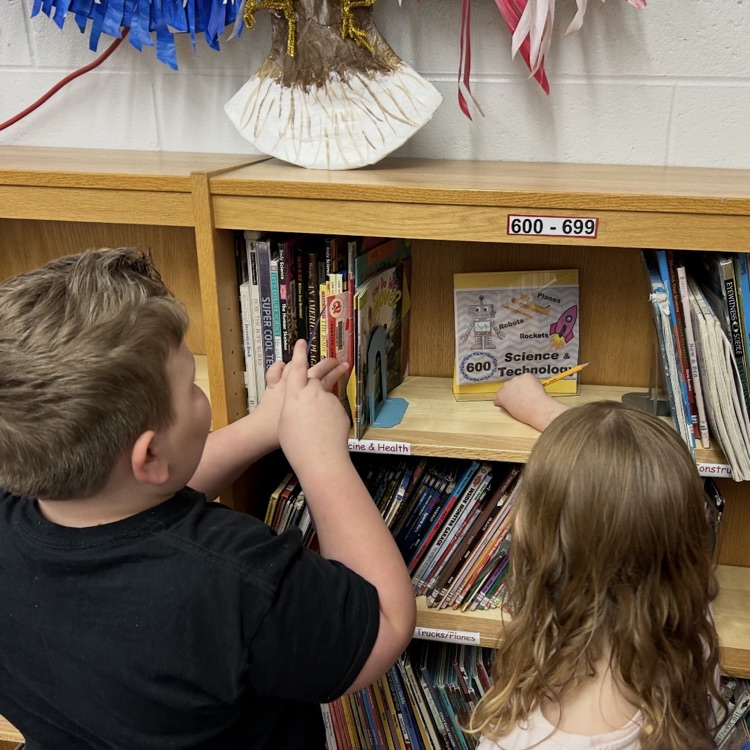 This week the 2nd graders learned how non-fiction is organized by Dewey Decimal System. They worked together to locate specific books and analyze the call numbers. #proudcardinal #growingreaders