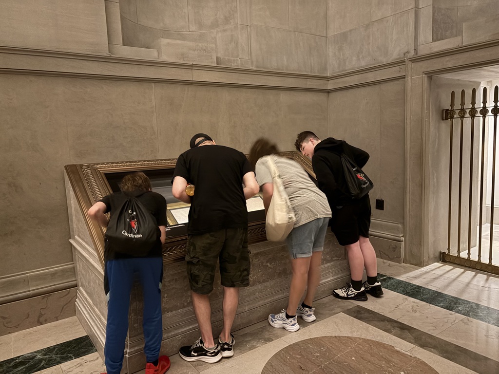 students peering into a display case