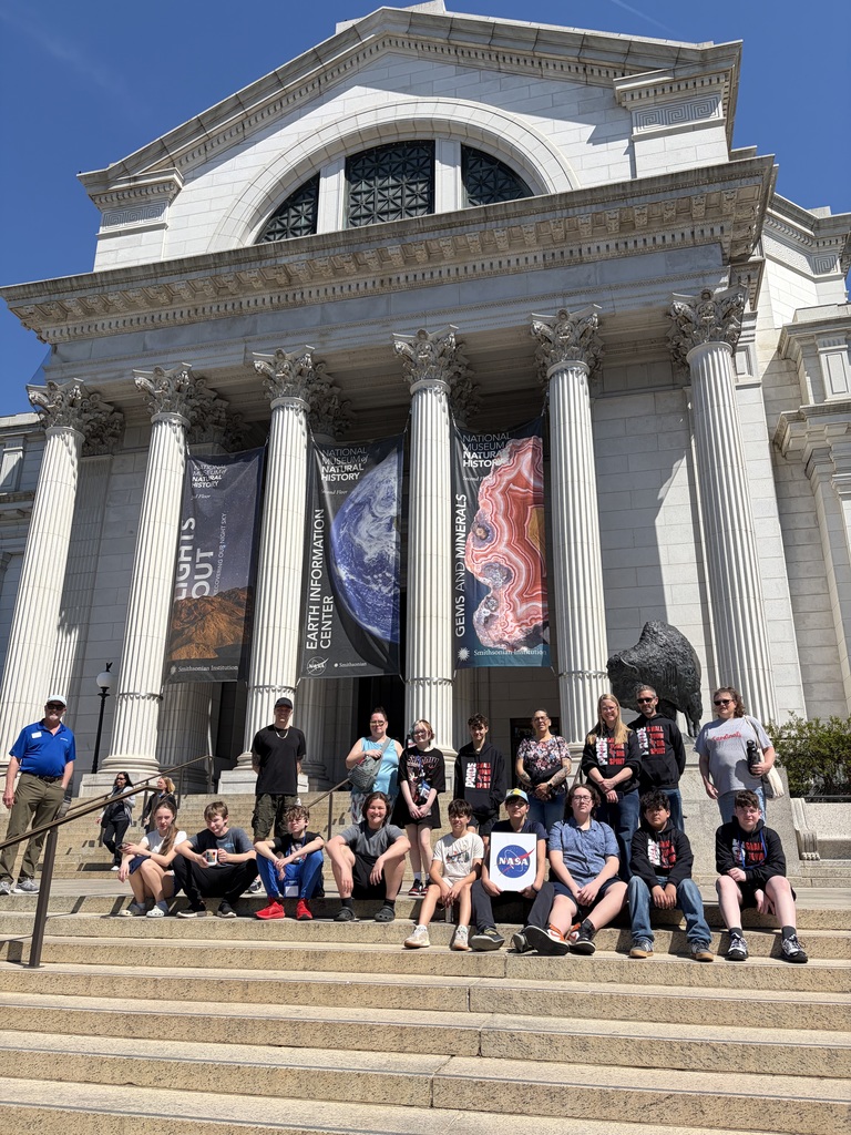 traveling group sitting on steps
