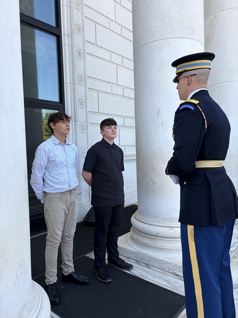 two students with a military guard
