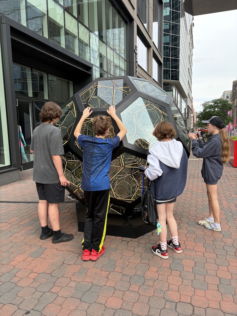 students studying a glass sphere