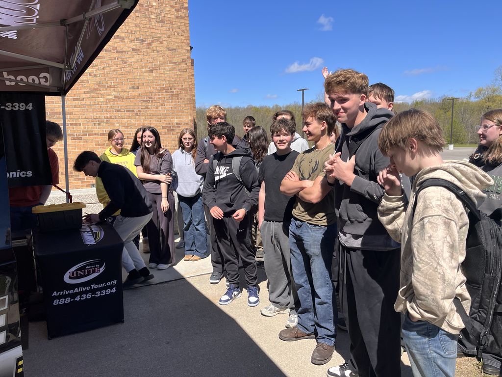 group of high school students engaged in a presentation