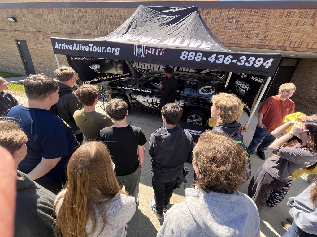 group of high school students engaged in a presentation