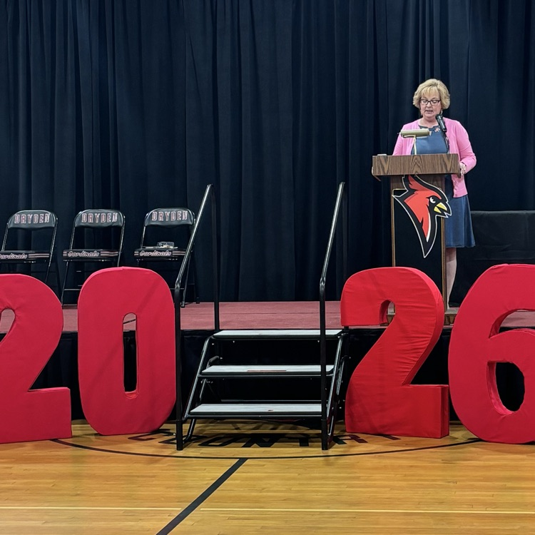 2026 sign with a principal at a podium
