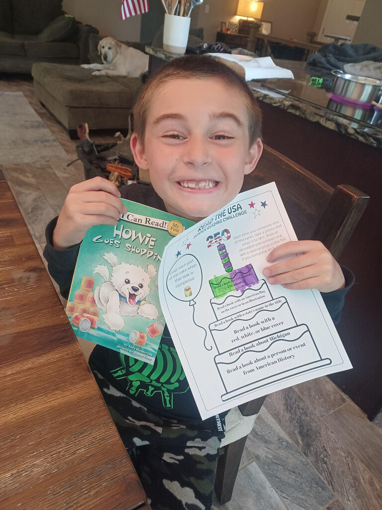 boy holding a reading calendar and book