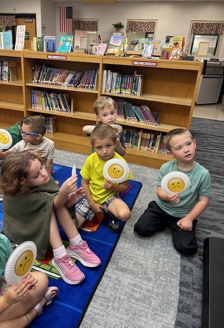 Good book care or bad book care?  The Kindergarteners analyzed photos and used their emoji cards to show their knowledge. #growingreaders #proudcardinal