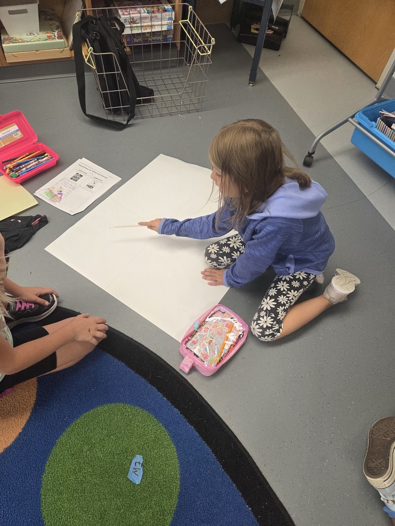 First graders worked in groups to design posters to help students remember how to play safe and have fun on our playground.
