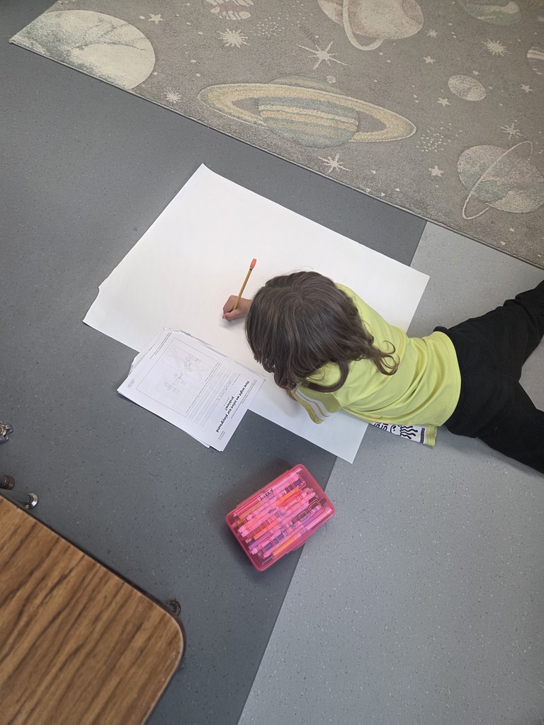 First graders worked in groups to design posters to help students remember how to play safe and have fun on our playground.