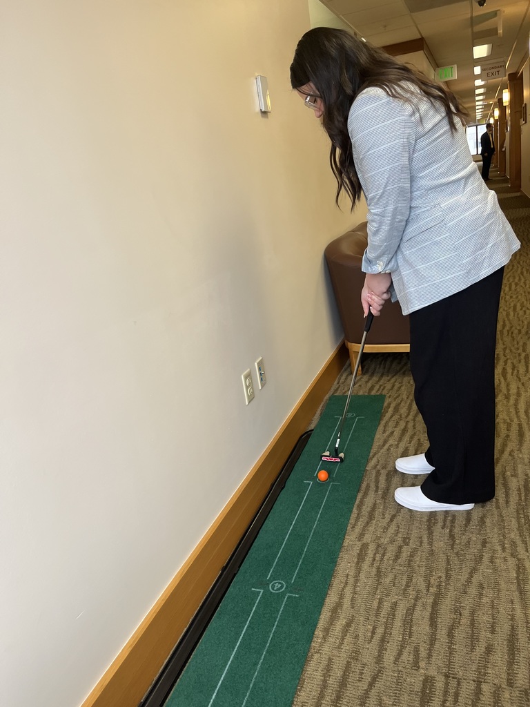 Molly practicing her golf game