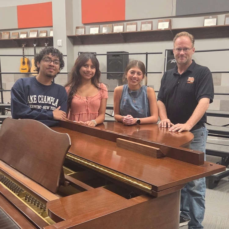 all state choir students with Mr armed in front of piano