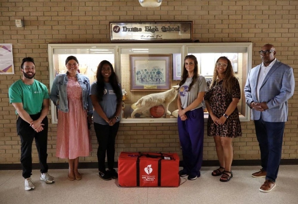 People standing with donated CPR kit