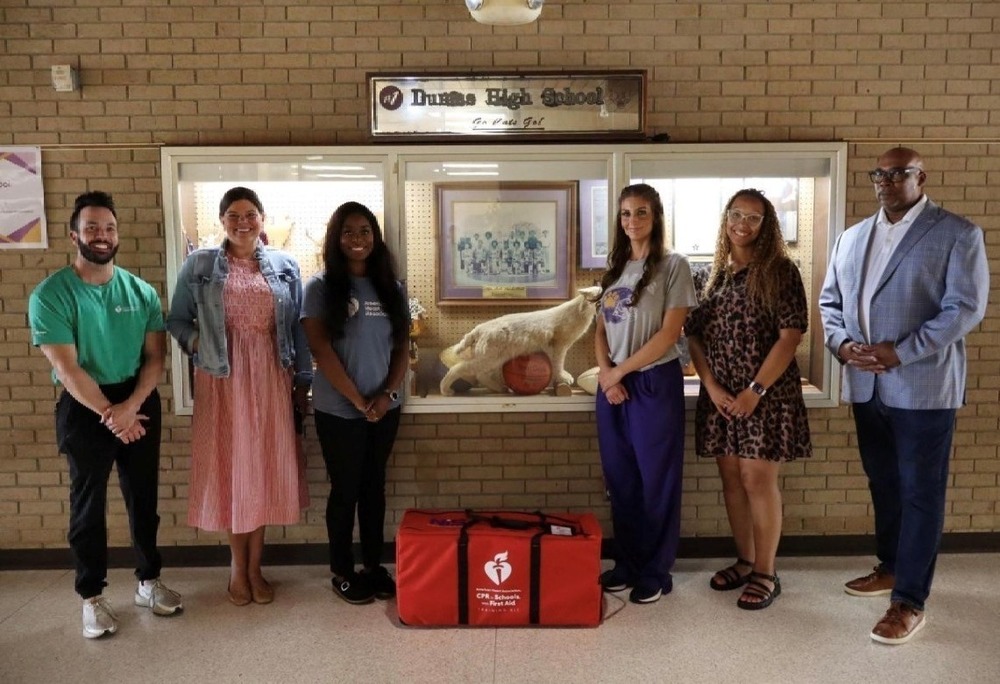 People standing with donated CPR kit
