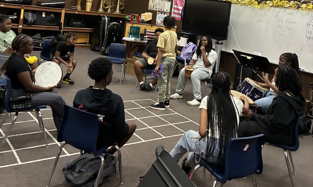 Middle School Student sitting in a circle with drums1